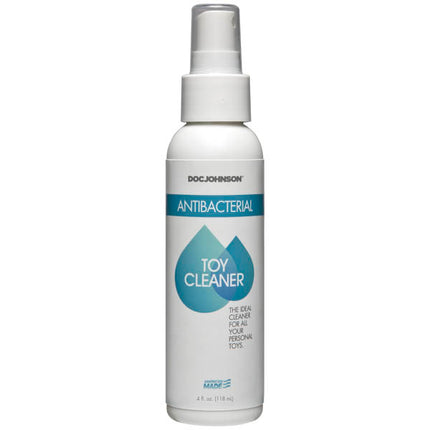 A bottle of Doc Johnson Antibacterial Toy Cleaner with a white spray cap and a label featuring the product name and a heart symbol.
