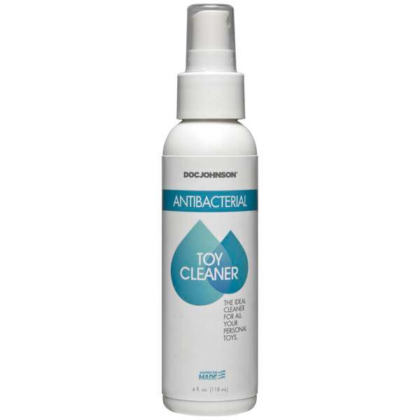 A bottle of Doc Johnson Antibacterial Toy Cleaner with a white spray cap and a label featuring the product name and a heart symbol.