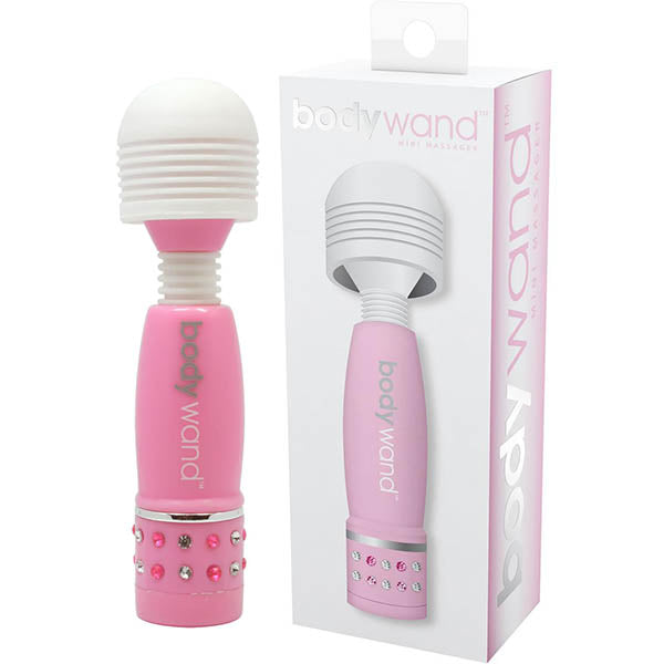The product image shows a pink mini massage wand with a white head and decorative elements on the handle. The massager is displayed both in hand and in its packaging, which is a white box with clear windows showing the product.