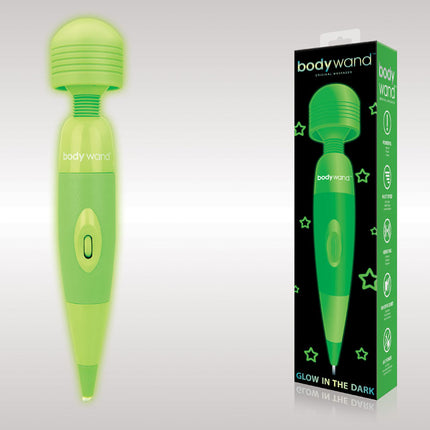 The image shows a glow-in-the-dark massage wand by Bodywand. The wand is green with a star pattern, and it's displayed next to its packaging which also glows green.