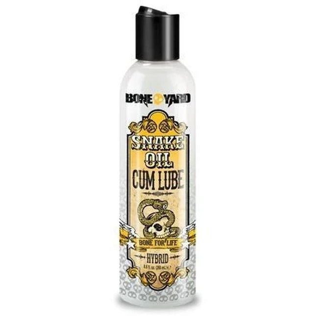 A bottle of Boneyard Snake Oil Cum Lube with a label featuring a snake illustration and text detailing the product name and brand.