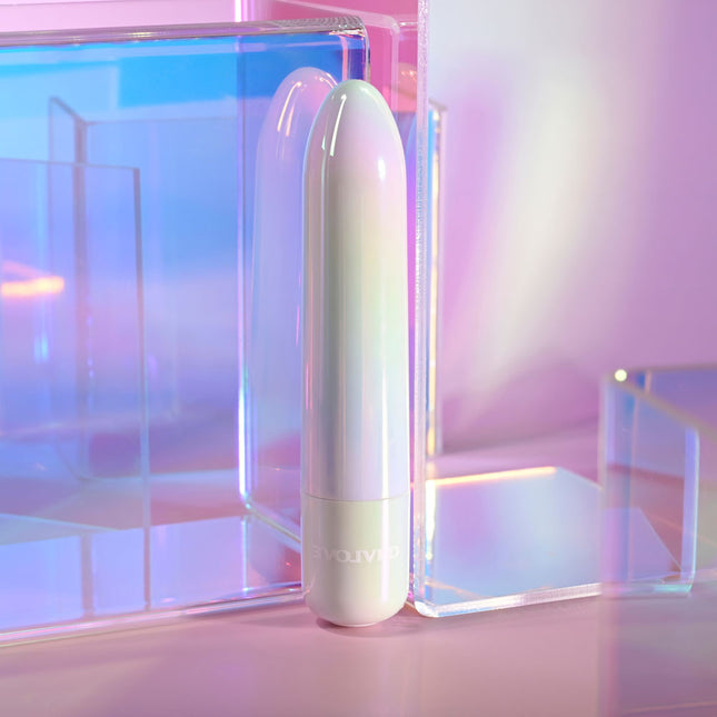 White cylindrical device with 'YUVO' branding on a reflective surface with pastel colors