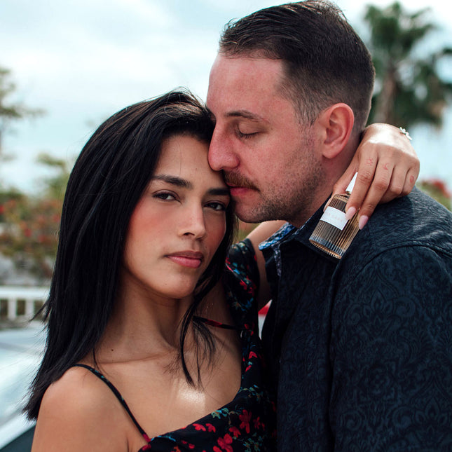 Couple embracing outdoors with a blurred background