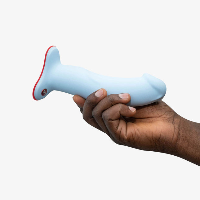 hand holding a FUN FACTORY THE BOSS Blue – Strap-On & Suction 7 Inch Dildo on a white background