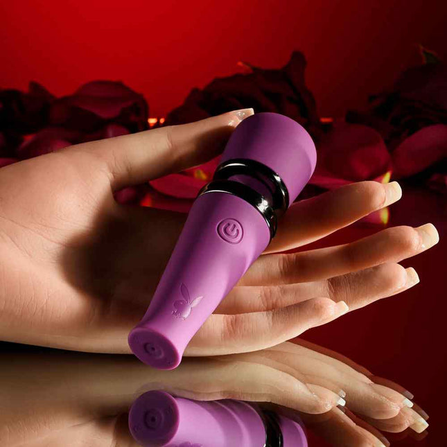 Female Hand holding Purple Playboy Wand Vibrator