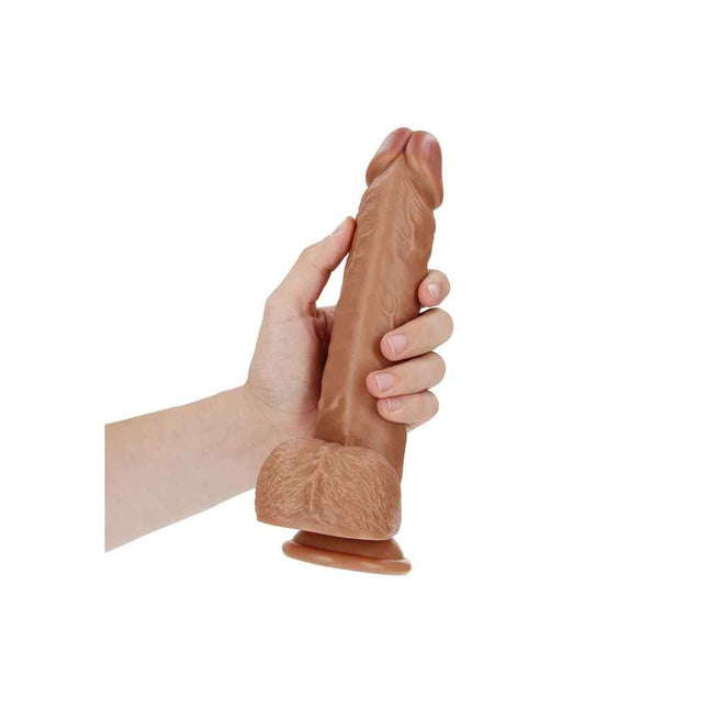 Hand Holding Tan REALROCK 9 Inch Realistic Suction Cup Dildo with Balls