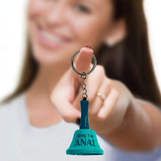 girl holding green novelty bell saying 'ring for anal'