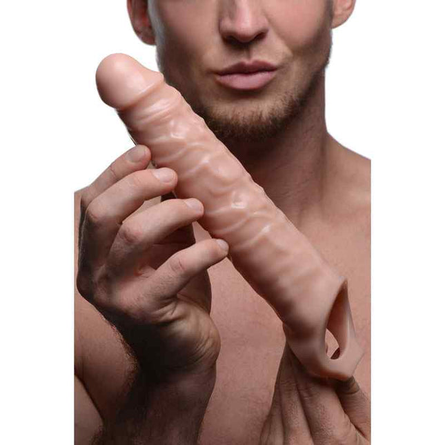 Man Holding Size Matters 3 Inch Flesh Penis Extender Sleeve