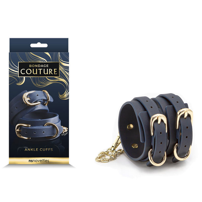 A pair of blue ankle cuffs with metal hardware, displayed alongside its packaging which reads 'Bondage Couture'.