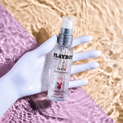 hand holding Playboy Pleasure SLICK STRAWBERRY Flavoured Water Based Lubricant - 60 ml