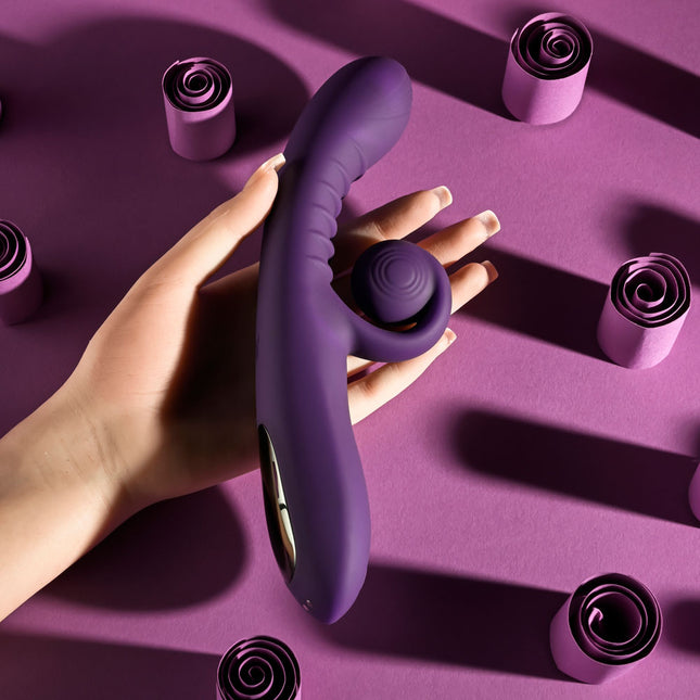 Hand holding Playboy CURLICUE Purple Rabbit Vibrator
