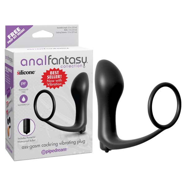 The image shows a black vibrating butt plug with a cock ring. The product is displayed both in and out of its packaging, which prominently features the brand Pipedream.