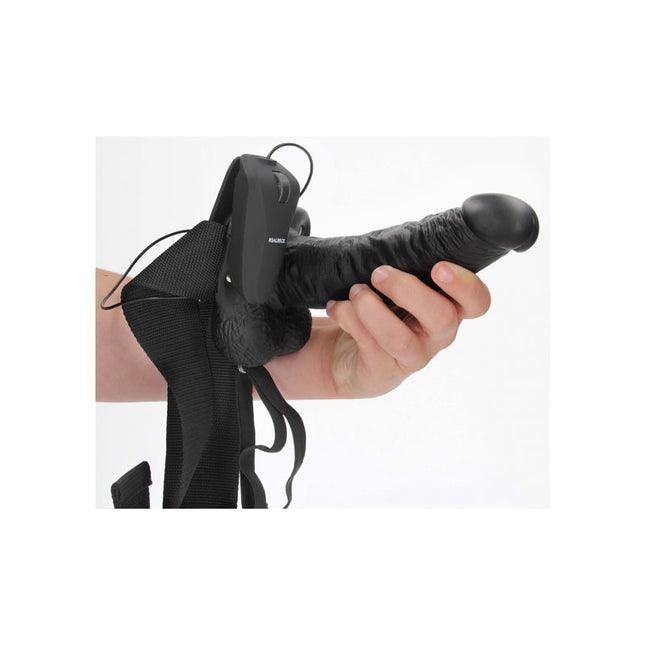 Hand holding REALROCK Vibrating Hollow Strapon 7 Inch Black Dildo with Remote