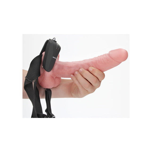 Hand holding REALROCK Vibrating Hollow Strapon with Balls 9 Inch Flesh Dildo