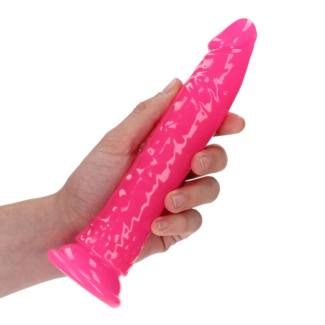 Hand Holding REALROCK 7 Inch Slim Glow in the Dark Neon Pink Dildo