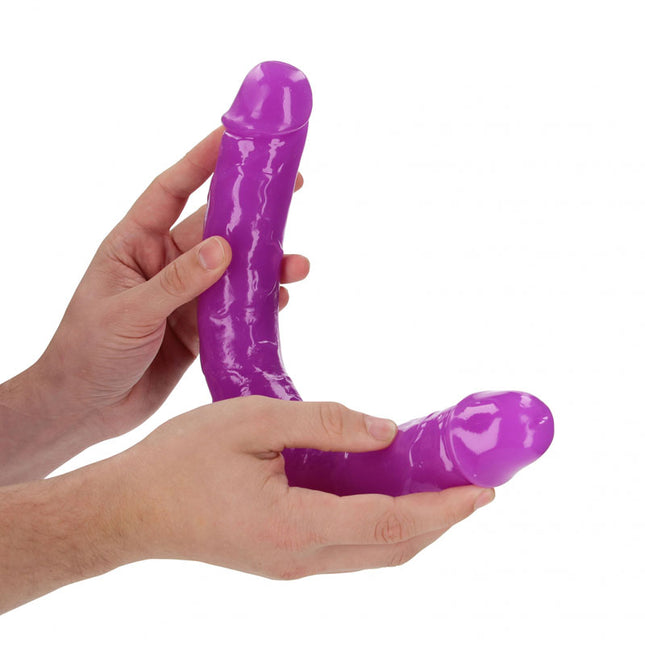 Hand holding REALROCK 15 Inch Glow in the Dark Purple Double Dildo