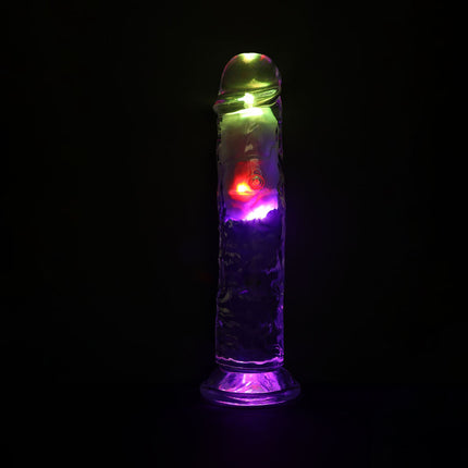 Colorful LED light-up dildo sex toy on a black background