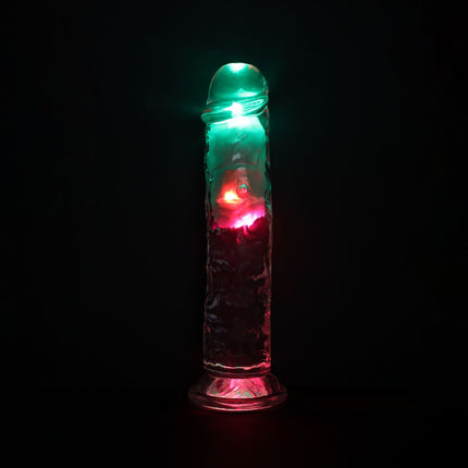 Dildo Sex Toy with green and red lights on a black background