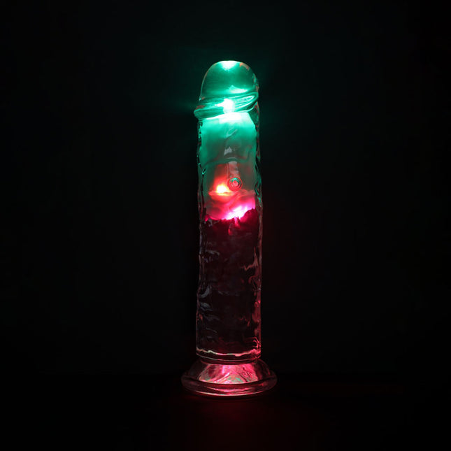 Dildo Sex Toy with green and red lights on a black background